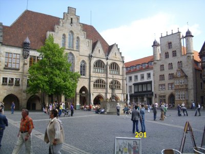 Farbfoto: Der Historische Marktplatz vor dem Rathaus in Hildesheim am Pfingstsonntag des Jahres 2010. In der oberen Bildhälfte links: Das Hildesheimer Rathaus. Davor der Rolandbrunnen. Fotograf: Kim Hartley.